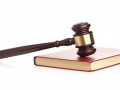Judge's gavel on red legal book